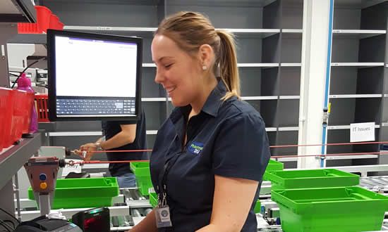 A member of Pharmacy2U staff uses three way barcode identification to check prescription, item, and labelling