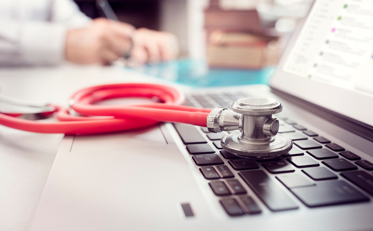 laptop with stethoscope on top