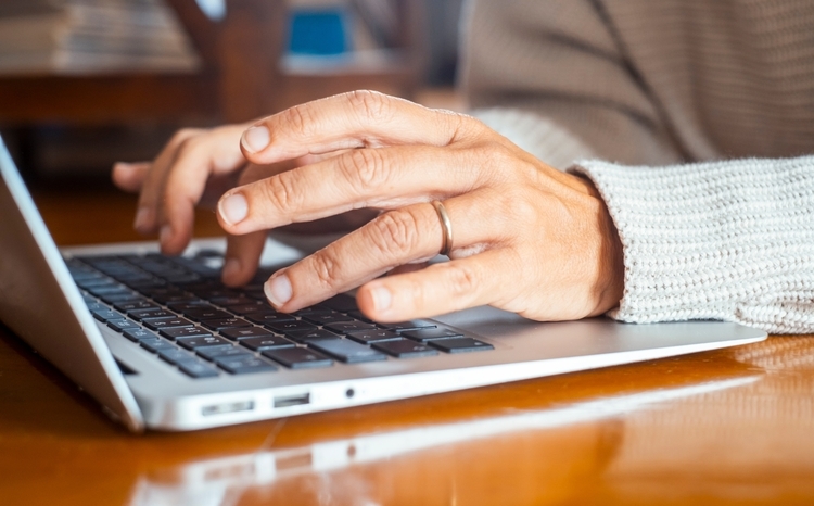 Close up of woman hands writing on keyboard laptop email or searching the net. People and online technology connection lifestyle. Working on the table with computer and software app